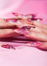 Human fingers with long fingernail over pink Royalty Free Stock Photo