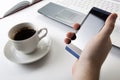 Human fingers near the notebook keyboard and smartphone Royalty Free Stock Photo