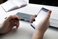 Human fingers near the notebook keyboard and smartphone Royalty Free Stock Photo