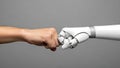 Human and robot hands fist bumping symbolizing collaboration and future technology Royalty Free Stock Photo