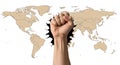Fist breaking through world map symbolizing power and change Royalty Free Stock Photo
