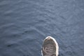 Human foot stepping forward above dark water surface representing risk mistake failure and wrong decision concept in uncertain Royalty Free Stock Photo