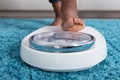 Human Foot Stepping On Weighing Scale