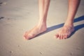 Human foot walking on white sand beach Royalty Free Stock Photo