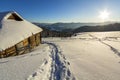 Human footprint path in white deep snow leading to small old wooden forsaken shepherd hut in mountain valley, spruce forest, woody Royalty Free Stock Photo