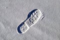 A human footprint on a snowy surface