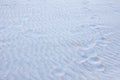 Human footprints of bare feet on textured sand