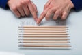 Human Hand Arranging Paper Clips In A Row