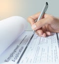 Human hand with ballpoint pen over application form Royalty Free Stock Photo