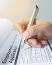 Human hand with ballpoint pen over application form Royalty Free Stock Photo