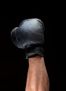 Human hand in black leather boxing glove raised up Royalty Free Stock Photo