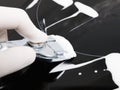 Human hand cleaning a ceramic hob. Macro detail. Royalty Free Stock Photo