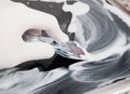 Human hand cleaning a ceramic hob with a scraper Royalty Free Stock Photo