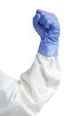 A human hand clench fist in a blue medical glove.