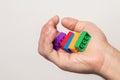 Human hand with colourful bricks over a white wall Royalty Free Stock Photo