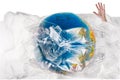 Human hand comes out of the plastic near the globe , human sinks in the plastic, our irresponsible, excessive consumption of plast