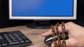 Human hand on computer mouse locked in old rusty chain. Copy space on monitor Royalty Free Stock Photo