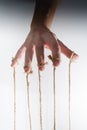 The human hand controls the puppet with the fingers attached to them threads Royalty Free Stock Photo