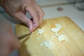 Human hand cutting garlic teeth into small pieces Royalty Free Stock Photo