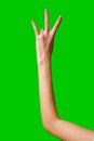 Human Hand Displaying the Number Three Against a Solid Green Background Royalty Free Stock Photo