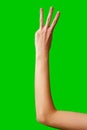 Human Hand Displaying the Number Three Against a Solid Green Background Royalty Free Stock Photo