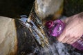 Human hand filling plastic bottle with water