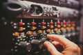 Human hand fine tuning levels on professional audio equipment Royalty Free Stock Photo