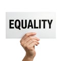 Hand holding a white sign with the bold black word EQUALITY, symbolizing social justice, human rights, and fairness, isolated on t Royalty Free Stock Photo