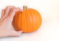 Human hand grabbed a pumpkin isolated on white background