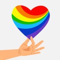 Human hand hold rainbow heart. LGBT concept