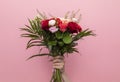 Human Hand Holding Beautiful Fresh Bouquet Of Flowers For Bride Or Occasion On Pink Royalty Free Stock Photo