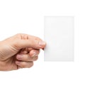Human hand holding a blank white business card or small rectangular paper isolated on white background Royalty Free Stock Photo
