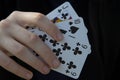 Human hand holding cards on a black background Royalty Free Stock Photo