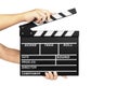 human hand holding clapperboard isolated on white