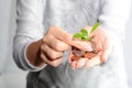 Human hand holding coins and a growing plant Royalty Free Stock Photo