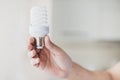 Human hand holding compact fluorescent light bulb. High quality and resolution beautiful photo concept Royalty Free Stock Photo