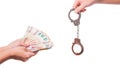 Human hand holding euro money and handcuffs. Fan of euro banknotes. Royalty Free Stock Photo