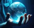 Human hand holding glass ball globe of the Earth with blue light inside, World environment and earth day concept Royalty Free Stock Photo