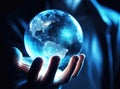 Human hand holding glass ball globe of the Earth with blue light inside, World environment and earth day concept Royalty Free Stock Photo