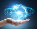 Human hand holding glowing digital Earth globe with network connection lines on a dark background Royalty Free Stock Photo