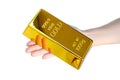 Hand holding gold bar 1kg