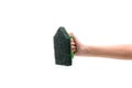 Human hand holding a green plastic scrubber isolated on white background Royalty Free Stock Photo