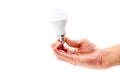 Human hand holding LED light bulb on white background Royalty Free Stock Photo