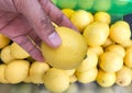 Human hand holding a lemon on blur background. Royalty Free Stock Photo