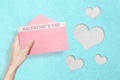 Human hand holding opened a pink envelope with Valentines Day text Royalty Free Stock Photo