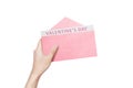 Human hand holding opened pink envelope with Valentines Day text