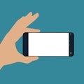 Human hand holding the phone horizontally . Black phone ,