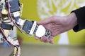 Human hand holding a robot hand with a handshake Royalty Free Stock Photo