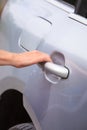 Human hand holding car door handle Royalty Free Stock Photo