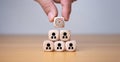 Human hand holding a wooden block which prints a target icon, Business goals and objectives concept, business competition